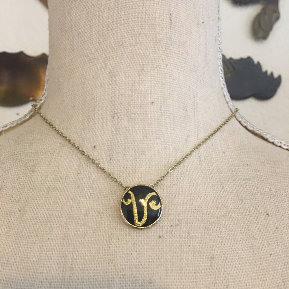 Gold tone black enamel initial pendant on chain